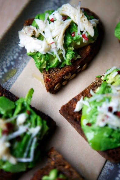 Smoked whitefish, pink peppercorns and avocado on rye bread